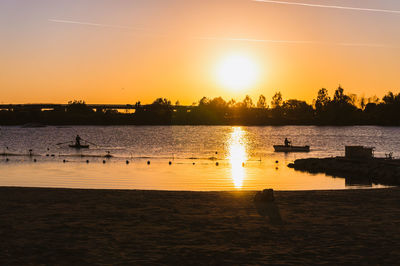 Scenic view of lake against sky during sunset