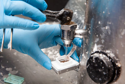 Scientist embedding tissues in paraffin blocks for sectioning using a paraffin dispenser. 