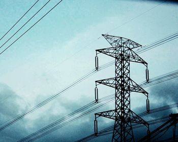 Low angle view of electricity pylon against sky