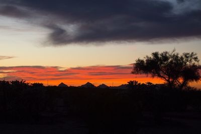 Silhouette landscape against scenic sky