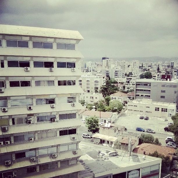 building exterior, architecture, built structure, sky, city, cloud - sky, residential building, high angle view, residential structure, building, cloudy, residential district, day, cityscape, city life, outdoors, overcast, car, no people, cloud