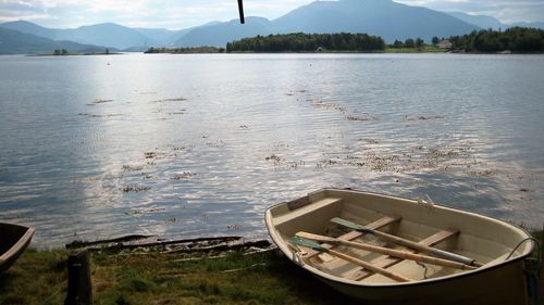 Calm lake with mountains in background