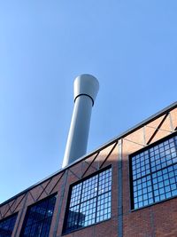 Low angle view of modern building against clear blue sky
