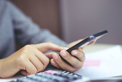 Close-up of hand using mobile phone