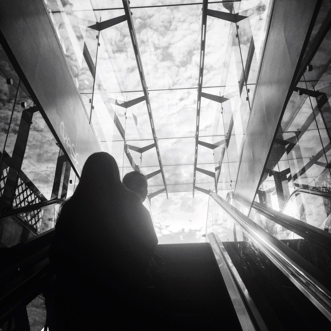 LOW ANGLE VIEW OF SILHOUETTE MAN ON GLASS