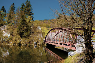 View of bridge over lake against trees