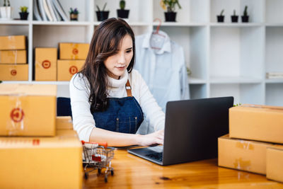 Young woman using laptop at home