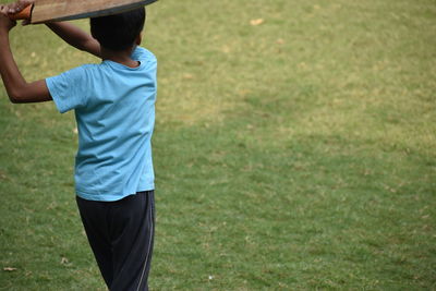 Rear view of man standing on field