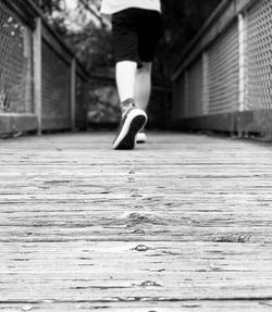 Low section of man walking on footpath