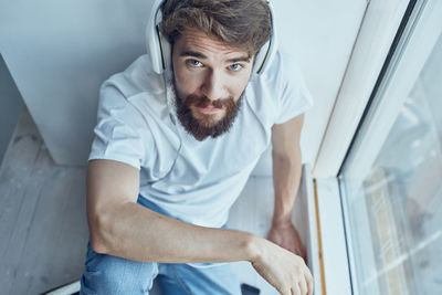 Portrait of young man sitting at home