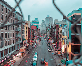 High angle view of city street and buildings against sky