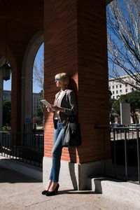 Full length of man standing against building in city