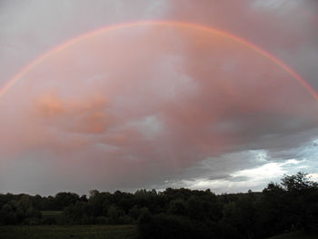 Rainbow over landscape against sky
