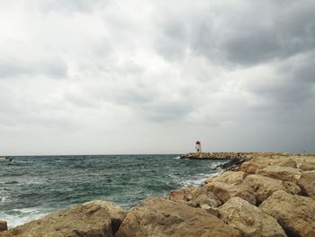 Scenic view of sea against cloudy sky