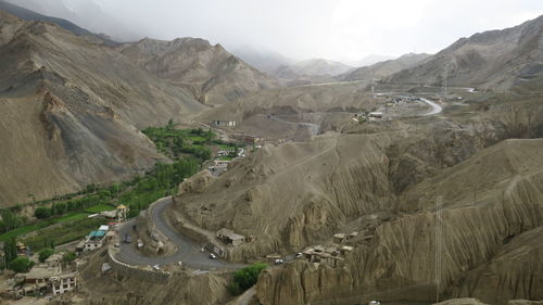 High angle view of land and mountains against sky