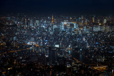 Aerial view of illuminated cityscape against sky at night