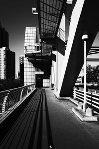 Railroad tracks amidst buildings in city against sky