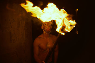 Close-up of a man burning in the dark