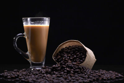 Close-up of coffee cup on table against black background