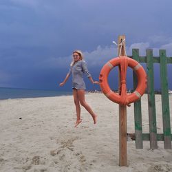 Full length of man on beach against sky