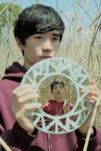 Portrait of boy holding plant