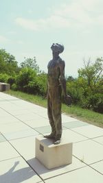 Statue against trees and sky