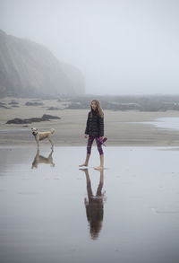 Full length of woman standing on beach