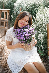 Portrait of a smiling young woman holding bouquet
