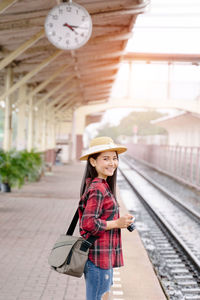 Portrait of senior man standing on railroad station platform