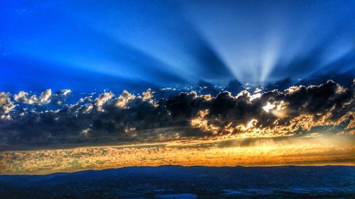 Scenic view of mountains against sky at sunset