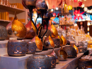 Close-up of illuminated candles in market