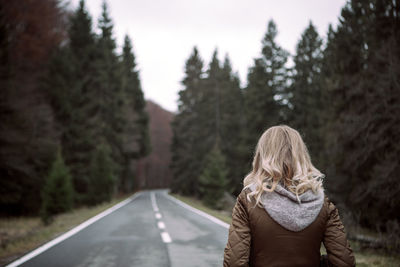 Rear view of woman with standing on road