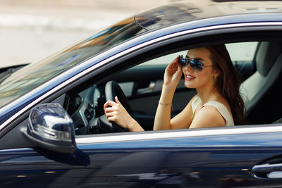 Side view of woman in car