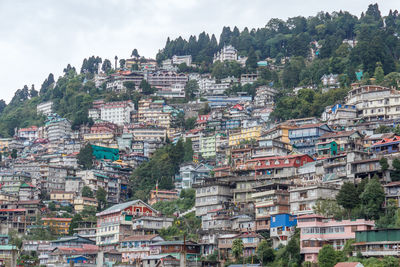 Buildings in town against sky