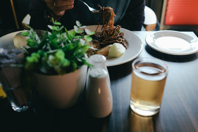 Midsection of person having breakfast in a restaurant