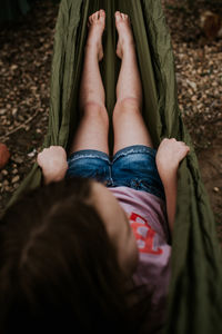 Overhead of young girl laying in hammock