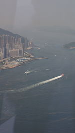 Aerial view of sea and buildings against sky