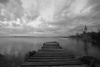 Pier over lake against sky