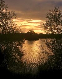 Scenic view of lake against sky during sunset