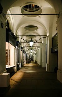 Empty corridor of illuminated building