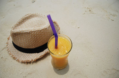 Close-up of drink on sand