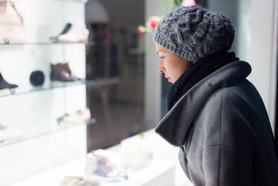 Mid adult woman standing in retail store