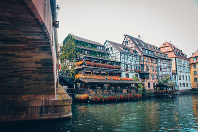 Bridge over river against buildings