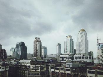 City skyline against cloudy sky