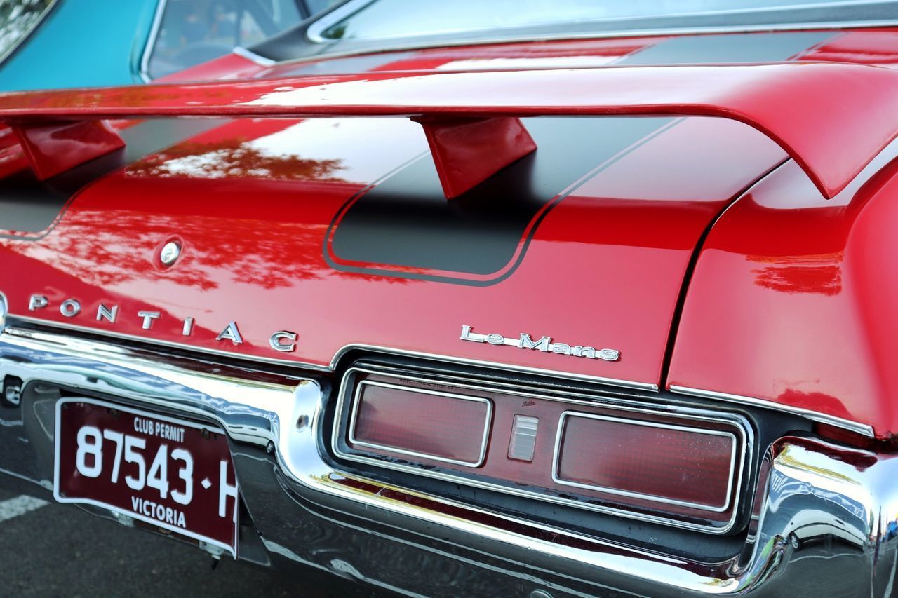 FULL FRAME SHOT OF RED CAR ON ROAD