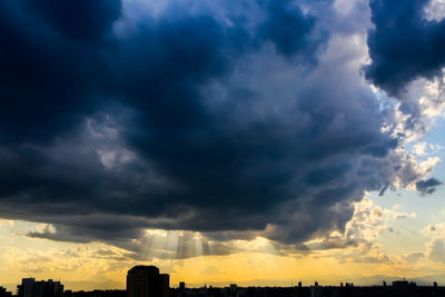 Low angle view of storm clouds over city