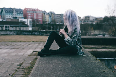 Woman sitting in city