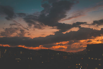 Silhouette buildings against sky during sunset