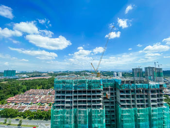 Aerial view of buildings against blue sky