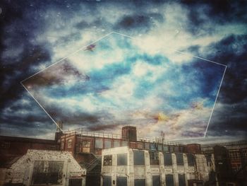 Low angle view of buildings against cloudy sky